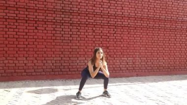 Video of sporty girl in gym outfit doing jump squat fat burning cardio workout.
