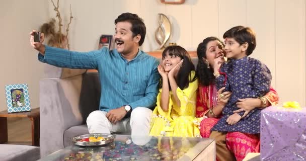 Indian Young Family Four Celebrating Raksha Bandhan Festival Sweet Laddoo — Stock Video