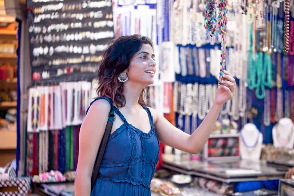 stock image Woman in sundress buying jewellery at street market