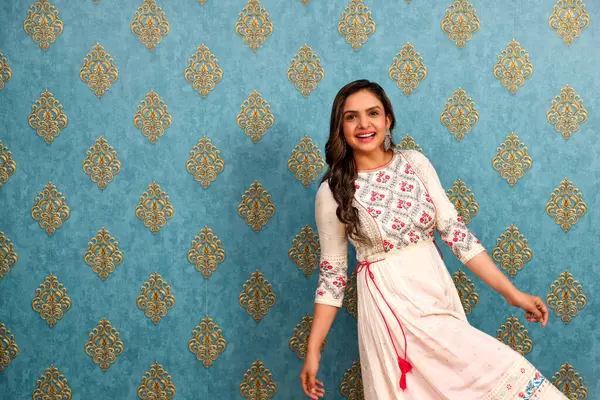 stock image A pretty model dressed in ethnic wear is smiling while posing in front of the camera