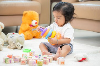 Bebek gökkuşağı dizme halkalarıyla oynuyor 