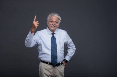 An old senior man giving an excited expression and showing his one finger clipart