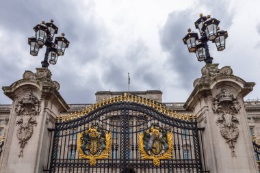 Londra 'daki Buckingham Sarayı' nın girişinde altın detaylar ve kraliyet amblemleriyle süslü bir kapı.