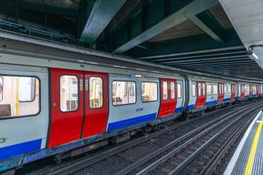 London Underground train with red, white, and blue design captured at a subway station platform