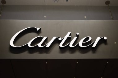 Elegant Cartier storefront logo displayed against a sleek black background, symbolizing luxury and sophistication. London, UK, 4 July 2023 clipart