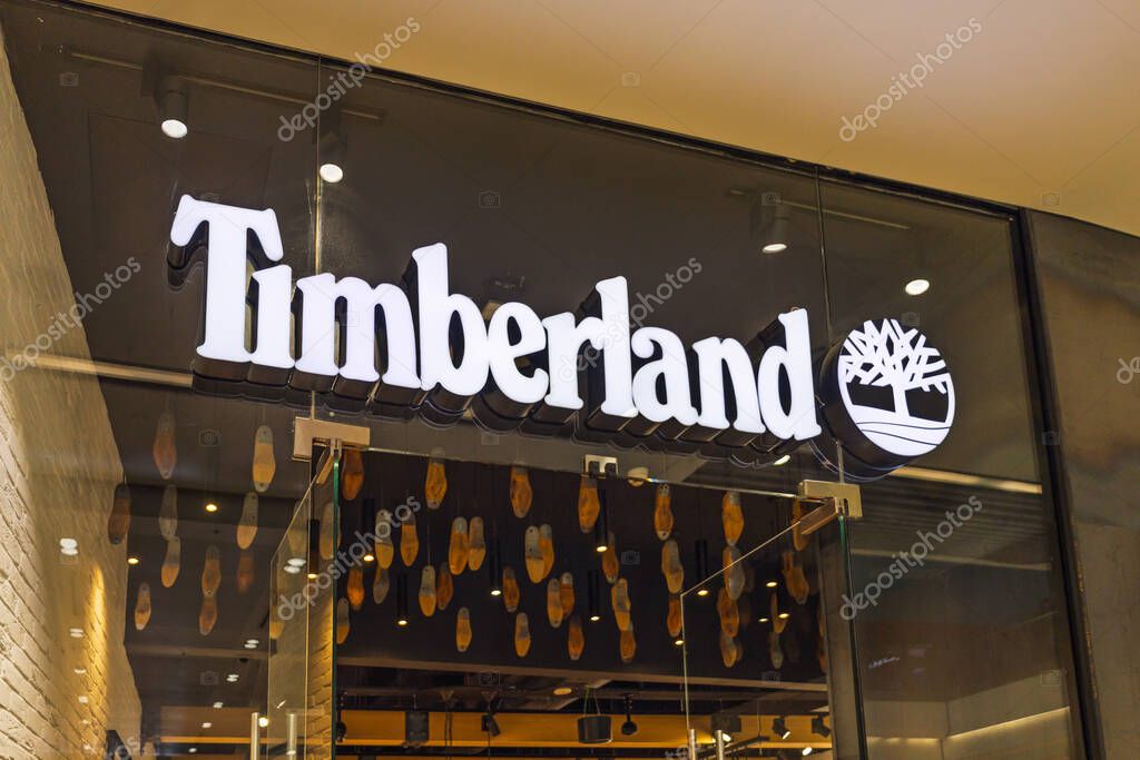 Timberland store entrance with illuminated logo and modern retail display in an indoor shopping mall. London, UK, 10 February 2024