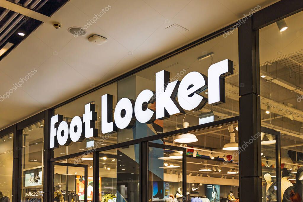 Foot Locker store entrance with illuminated signage and modern retail layout inside a shopping mall. London, UK, 10 February 2024