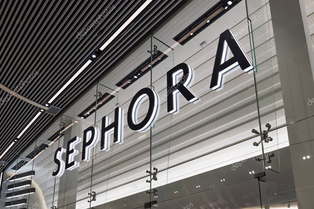Illuminated Sephora store sign in a modern shopping mall. Luxury beauty retailer specializing in cosmetics, skincare, and fragrance products. London, UK, 10 February 2024