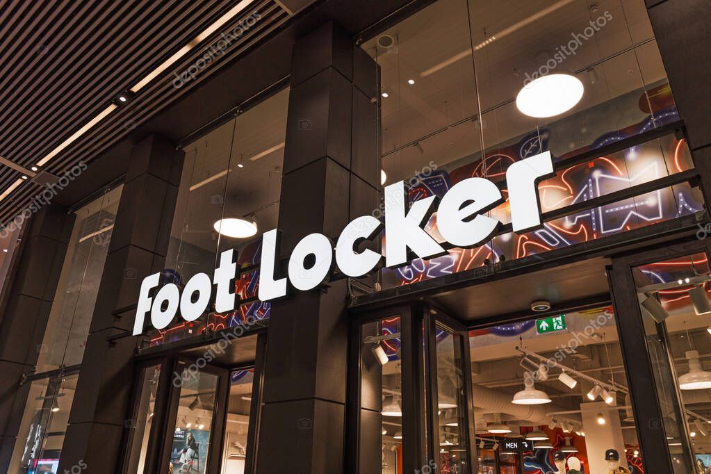 Illuminated Foot Locker store sign in white, showcasing popular sports footwear retail brand inside a shopping mall. London, UK, 10 February 2024