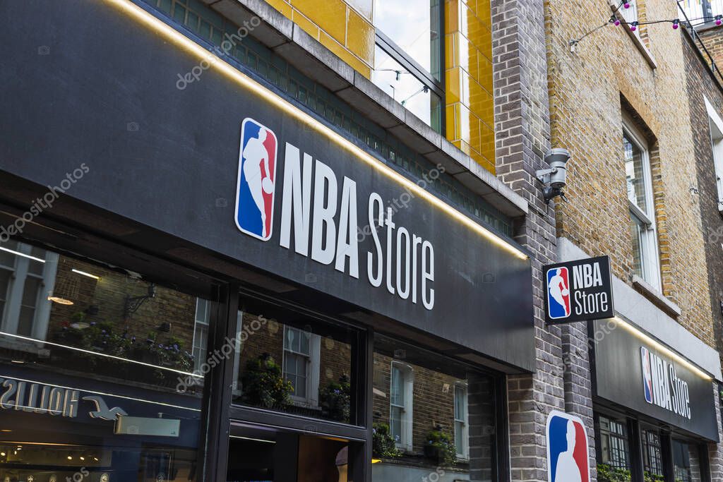 NBA Store storefront with bold black signage and logo on city street in busy shopping area. London, UK, 3 March 2024