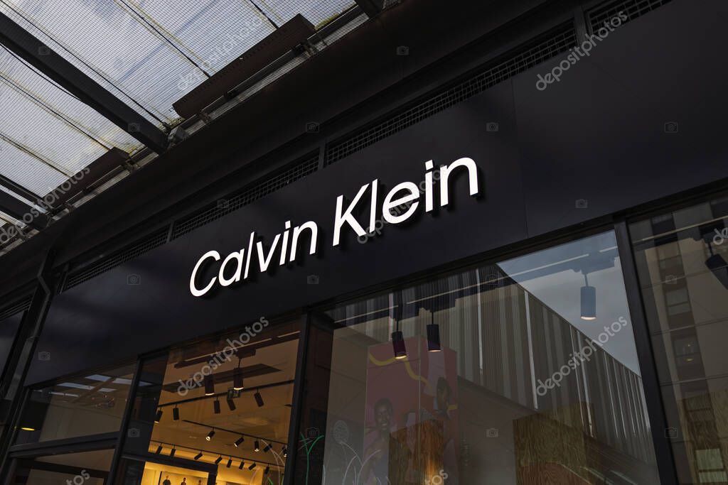 Calvin Klein store exterior with bold illuminated logo and stylish retail shopping space. London, UK, 17 March 2024