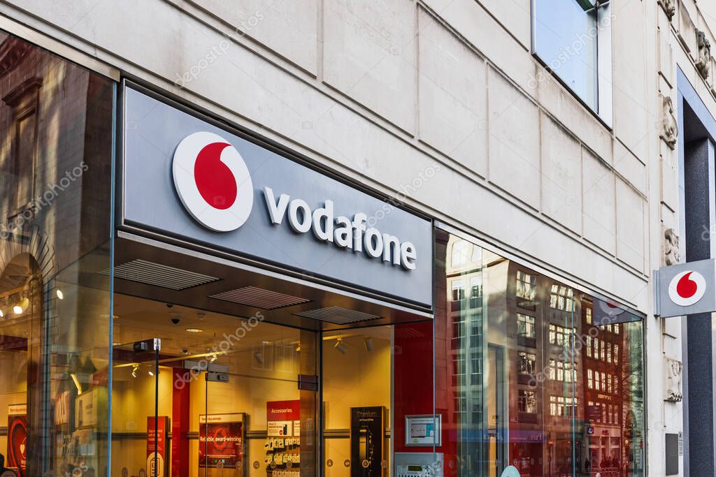 Vodafone storefront showcasing vibrant branding and modern architecture in a bustling urban setting. London, UK, 29 March 2024