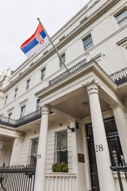 Sırbistan 'ın Londra Büyükelçiliği tarihi beyaz bina cephesinde Sırp bayrağıyla. Londra, İngiltere, 6 Nisan 2024
