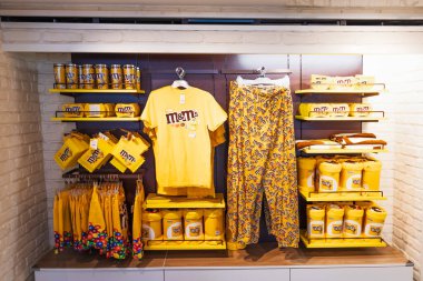 Parlak bir perakende şekerci dükkanında çikolata paketleri, markalı kıyafetler, peluş oyuncaklar ve kupalar sergileniyor. Londra, İngiltere, 2 Haziran 2024