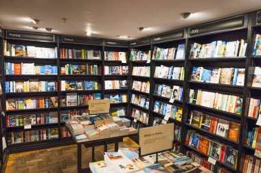 Londra, Waterstones Piccadilly 'de organize kitapçı rafları ve sergiler. Yığınlanmış kitaplar, kategori tabelaları, rahat ışıklandırma ve sakin bir tarama alanı. Londra, İngiltere, 8 Haziran 2024