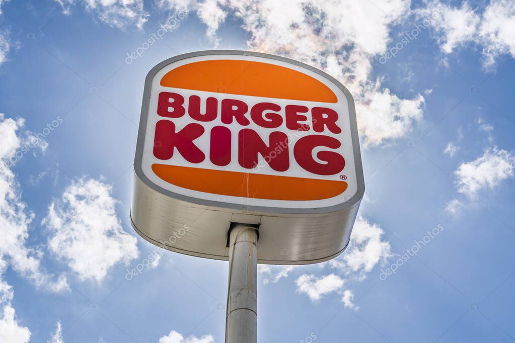 Burger King pole sign with the classic logo against a blue sky. London, UK, 15 June 2024