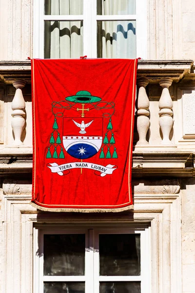 Red flag with the slogan faith hope love (vjera nada ljubav) on a building in Dubrovnik, Croatia.