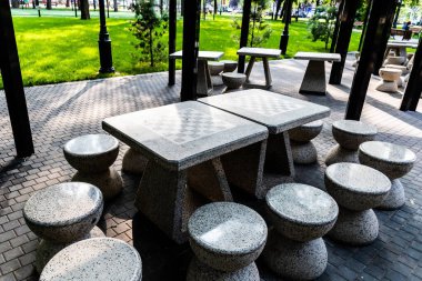 Satranç oynamak için masa ve sandalyeli oyun parkı. Boş satranç masaları ve sandalyeler