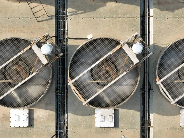Aerial view of the cooling units of a thermal power plant. Assembly of powerful rotating fans cooling excess thermal energy in operation. Detail of the equipment of the thermal power plant.