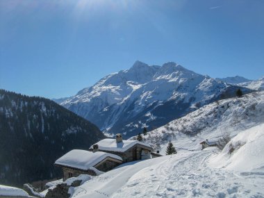 Mountain cottage nestled in the snow