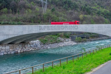 S.Pellegrino Terme Italy 5 April 2024: Truck for transporting mineral water on the Brembo river bridge clipart