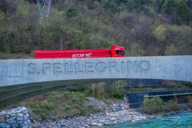 S.Pellegrino Terme Italy 5 April 2024: Truck for transporting mineral water on the Brembo river bridge clipart