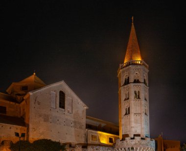 External facade of Porta Reale and the ancient walls with the bell tower of the Church of San Biagio di Finalborgo clipart