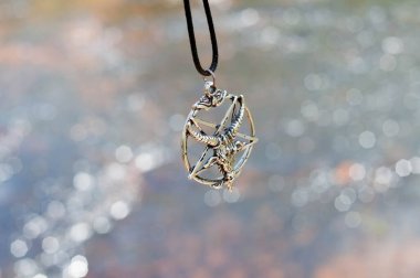 Closeup photograph of my pentagram with the river behind