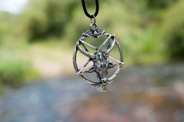 Closeup photograph of my pentagram with the river behind
