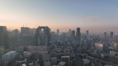 Aerial Pan over Central Osaka from Umeda to Fukushima at Sunrise. High quality 4k footage