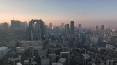 Aerial Departure from Central Osaka High Rises and Haze at Sunrise. High quality 4k footage