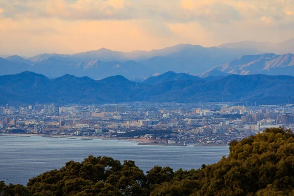 Beautiful Sunset Color in Sky Over Mountains and Sprawling City on Coast. High quality photo