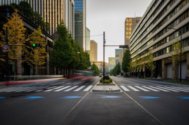 Traffic blurs through downtown intersection with early morning light. High quality photo