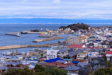 Awaji, Japan - January 16, 2023: Concrete breakwaters protect port at small fishing village of Iwaya . High quality photo
