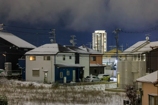 Snow Covered Suburban Houses Distant Luxury Apartment Tower Night High — Stockfoto