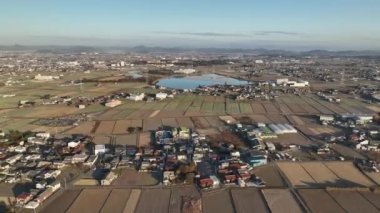 Aerial pullback over rural community and dry fields on winter morning. High quality 4k footage
