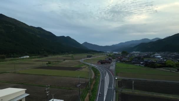 Two Motorcycle Riders Curved Road Small Town Japan Rural Landscape — Stock Video