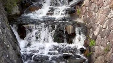 Nehirdeki kayaların üzerinden akan su antik taşlarla doludur. Yüksek kalite 4k görüntü