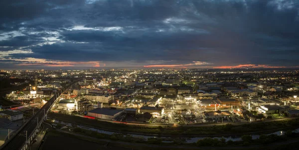 stock image Panoramic aerial view of elevated train tracks and city lights after sunset. High quality photo