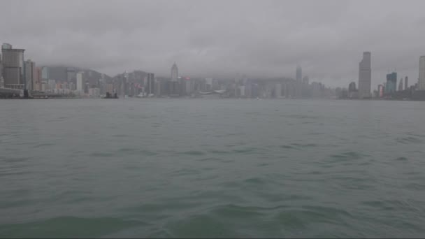 雨の日にビクトリア港の水から香港のスカイラインを見る 高品質の4K映像 — ストック動画