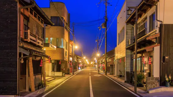 stock image Lights on empty main street by closed shops and buildings in Takeda Town . High quality photo