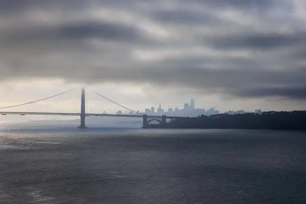 stock image Low dark clouds over Golden Gate Bridge and San Francisco skyline. High quality photo