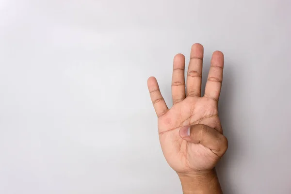 stock image number 4 hand sign isolated on white. pointing the finger. man hand number four gesture