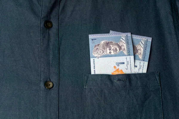 Close up of malaysian ringgit in  shirt pocket. Banknotes of Malaysia.