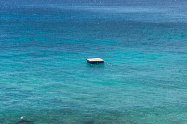 A wooden raft for sunbathing on water. Resort swim lay float on wooden raft