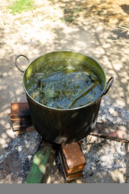 Asian traditional method of cooking. Boiling food with steam boiler and using fire woods.  clipart