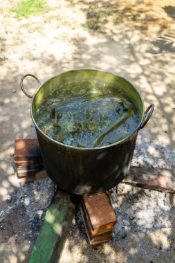 Asian traditional method of cooking. Boiling food with steam boiler and using fire woods.  clipart