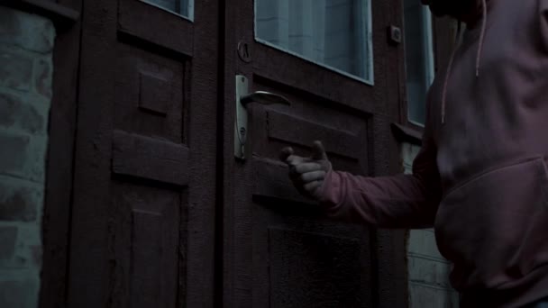 Ein Mann Kapuzenpulli Klopft Die Alte Tür Eines Alten Hauses — Stockvideo