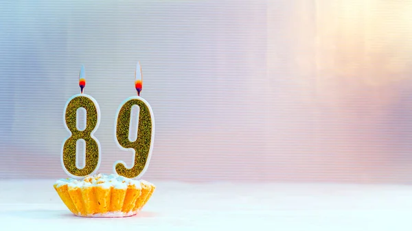 Happy birthday card from candles with the number 89 , golden numbers from candles for congratulations on any holiday