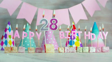 Happy birthday number 28 in pink pastel colors for a girl or woman. Happy birthday greeting card.